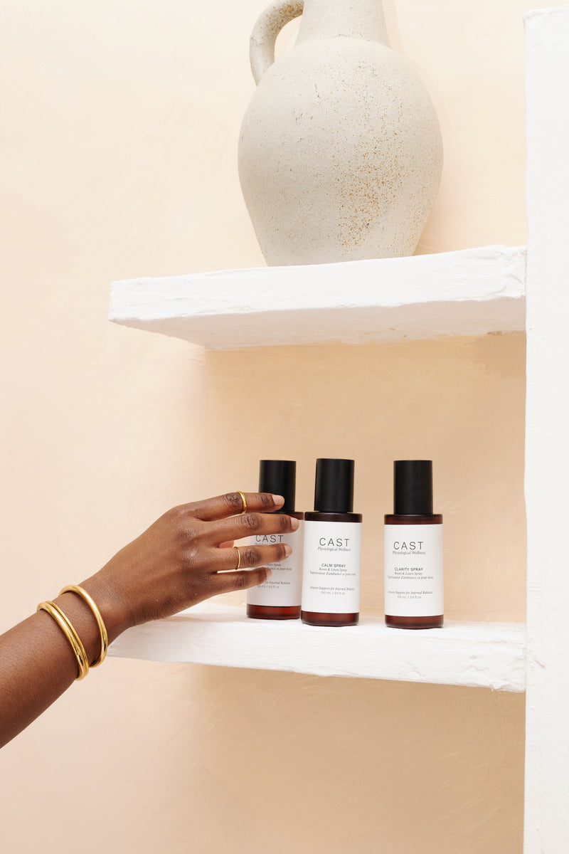 Cast sprays on shelf. Woman reaching for a spray.